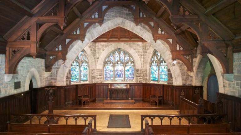 Interior view of the Page Memorial Chapel, built in 1906 by the family of Alanson and Elsie (Benson) Page in their memory. The chapel is famed for its Tiffany stained glass windows and memorial tablets.