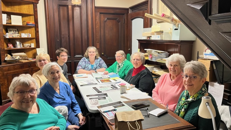The Auction Planning Committee gathered on March 7 at the Richardson-Bates House Museum. From left to right: Lyn Patterson, Charlene Mitchell, Carol Shannon, Greg Caster, Co-Chair Jennifer Bertollini, Peg McKinstry, Co-Chair Mary Kay Stone, and Mary Shanley. Photo courtesy of Eva Corradino. 