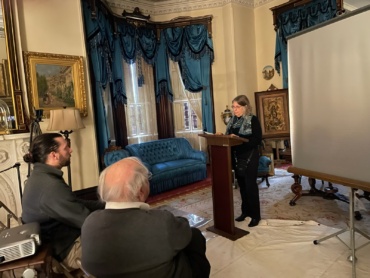 Mary Himes, President of the Scriba Historical Society, prepares her presentation as Michael Pittavino and George DeMass, seated, observe, at the 2025 Medal of Honor Day event.