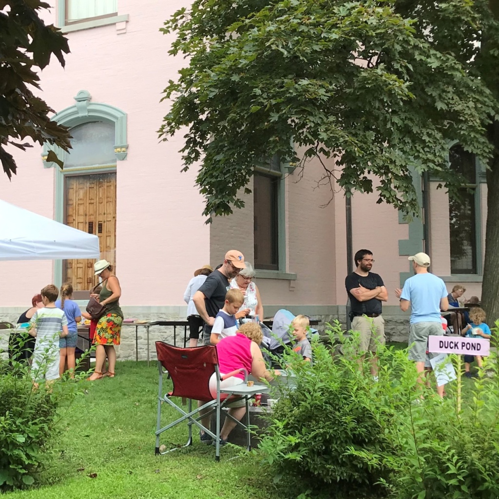 Volunteers and visitors occupy the front and side lawns of the museum of Family Fun Day.