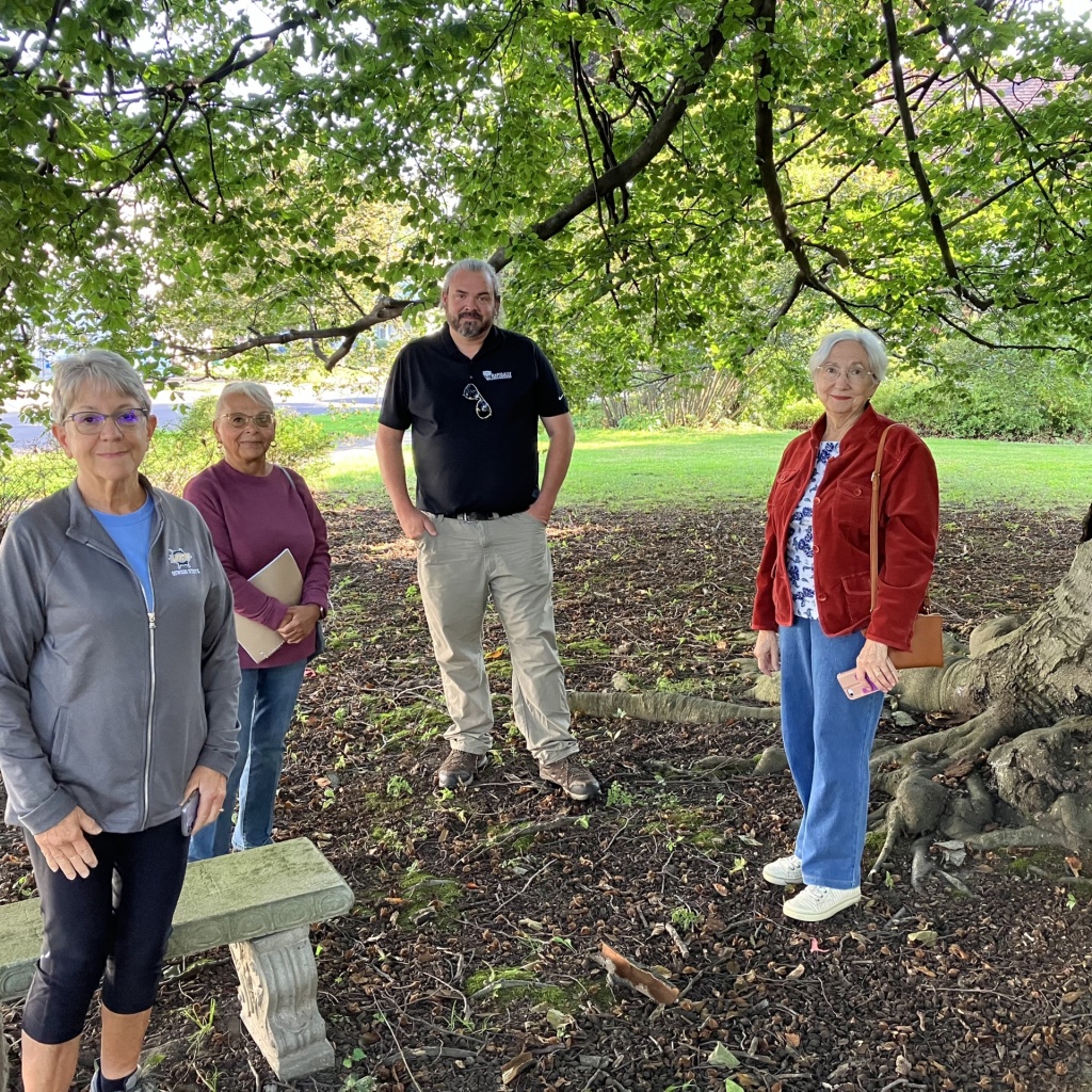 From left to right, Eva Corradino, Linda Shurr of the Oswego Garden Club, Greg Portsline of Bartlett and Charlene Mitchell, stand under the Copper Beech tree on the museum property.