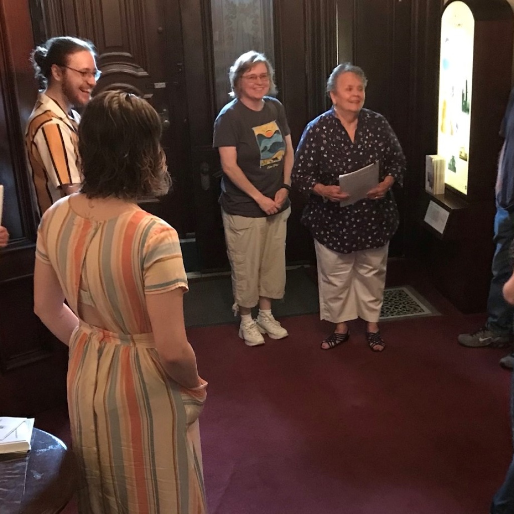Board member and docent Peg McKinstry gives a tour to a group of visitors.